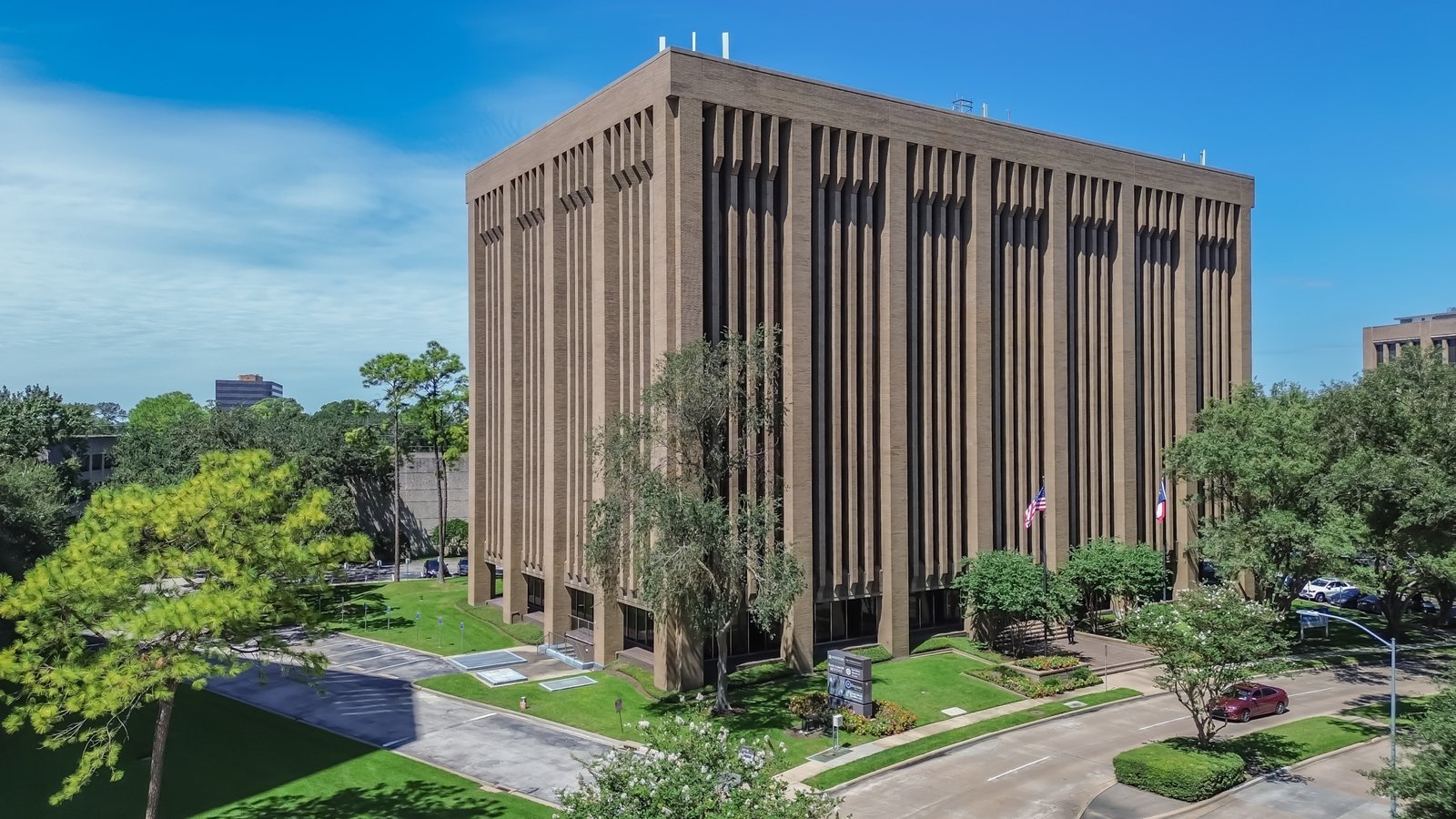 Aerial view of an office building surrounded by landscaped grounds
